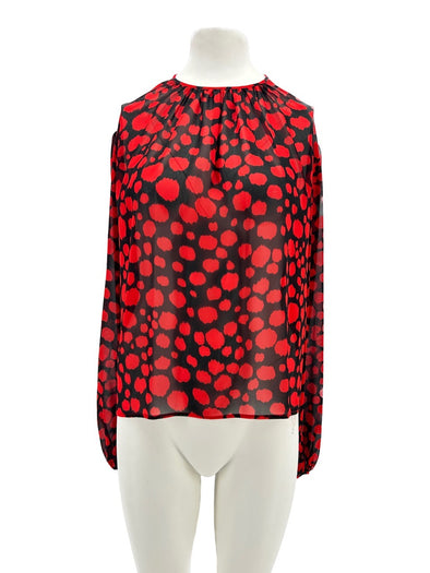 Blouse noire à pois rouges