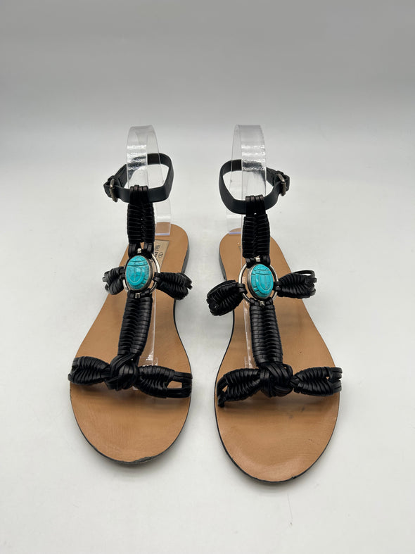 Sandales noires en cuire avec une pierre bleue